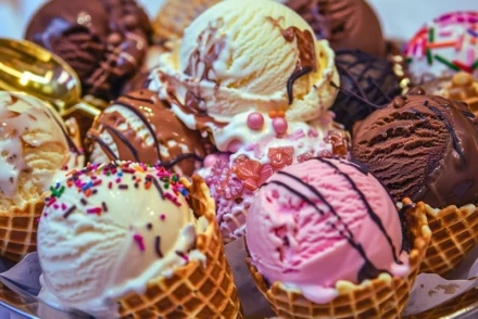 Different flavors of ice cream on a ice ream cones.